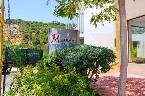 Matador Hotel signage with the hills of Mansourieh in the background